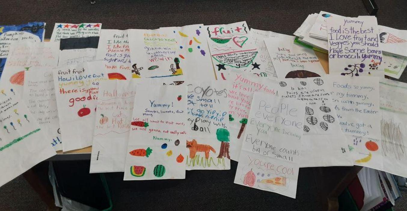 Page students decorated plain paper bags for Kids Food Basket.