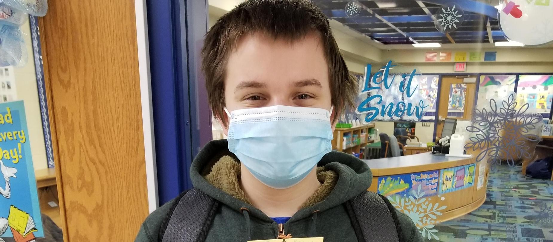 Student wearing mask posing for camera