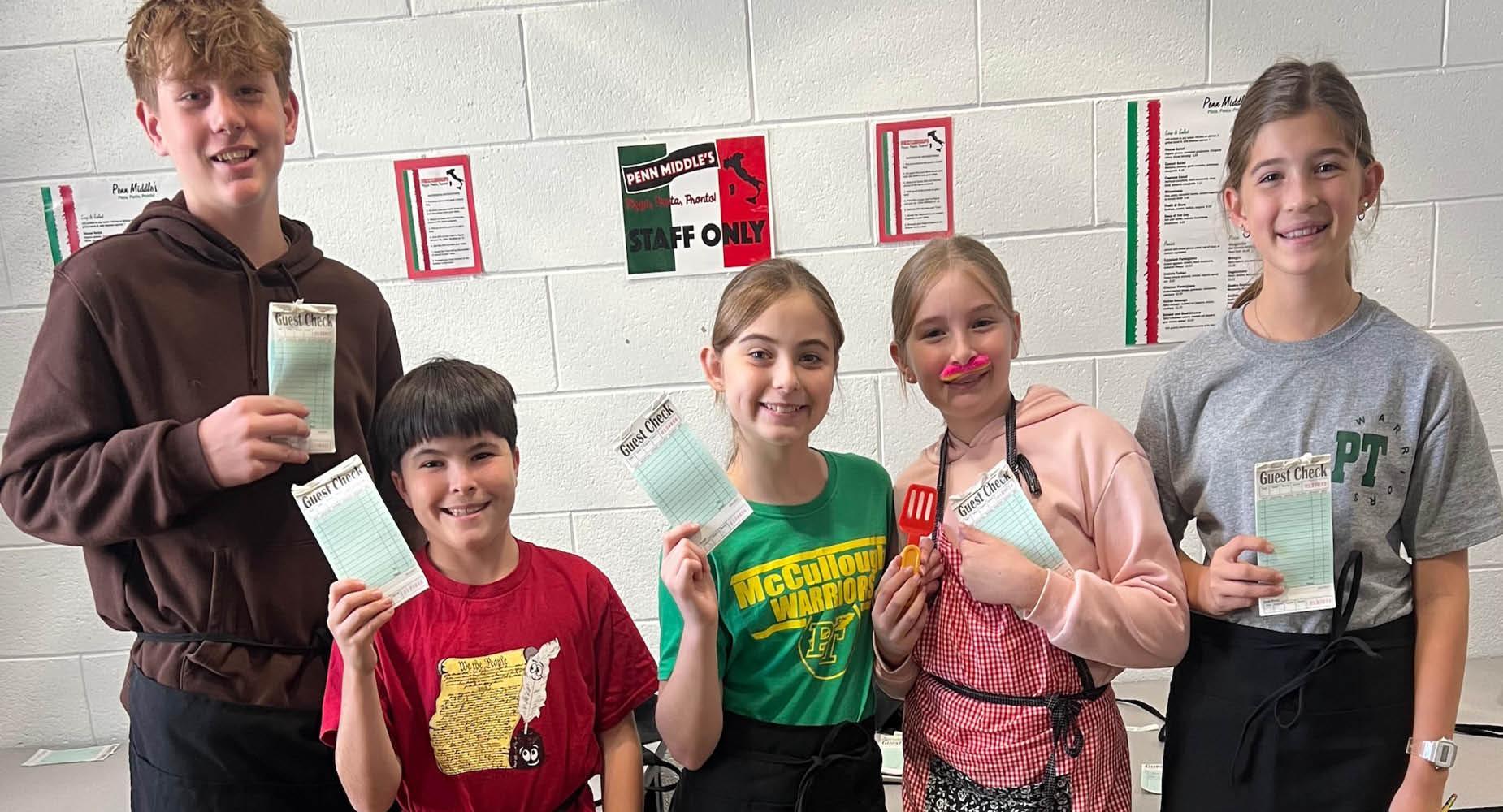 During a math project, 6th-graders Jackson Prather, Aiden Milko, Shylie Immel, Coraline Ward, and Adalina Ament total up their customers’ checks, calculate the tip, and present the final cost per person to their tables