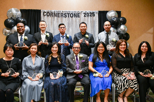 12 Classified Employees pose for a photo holding their award.