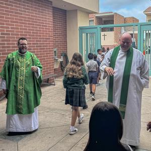Students exiting mass greeted by Fr. Matt and Fr. Jonathan