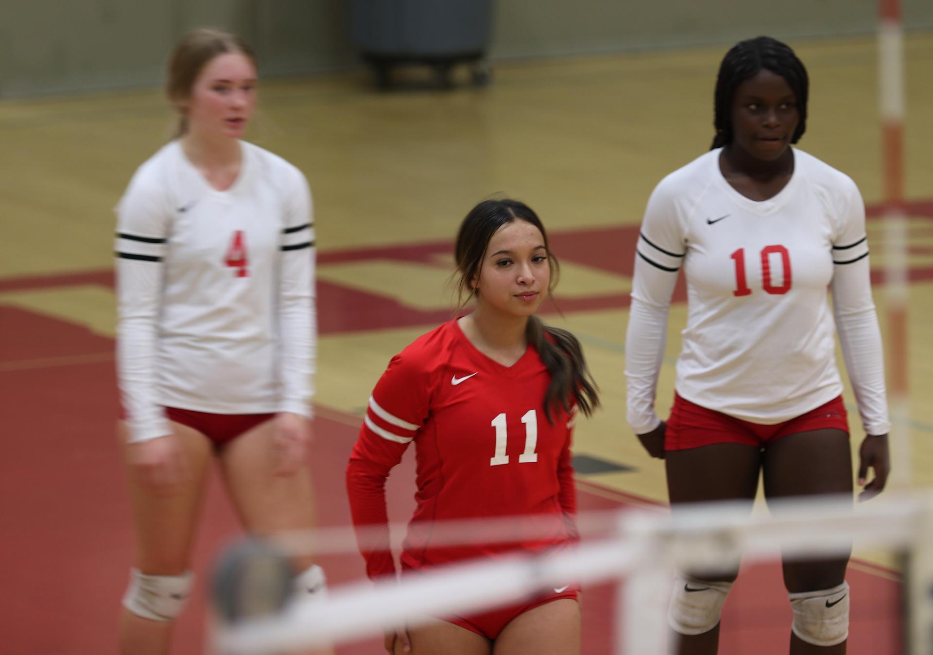 varsity volleyball players in action against Fresno Christian