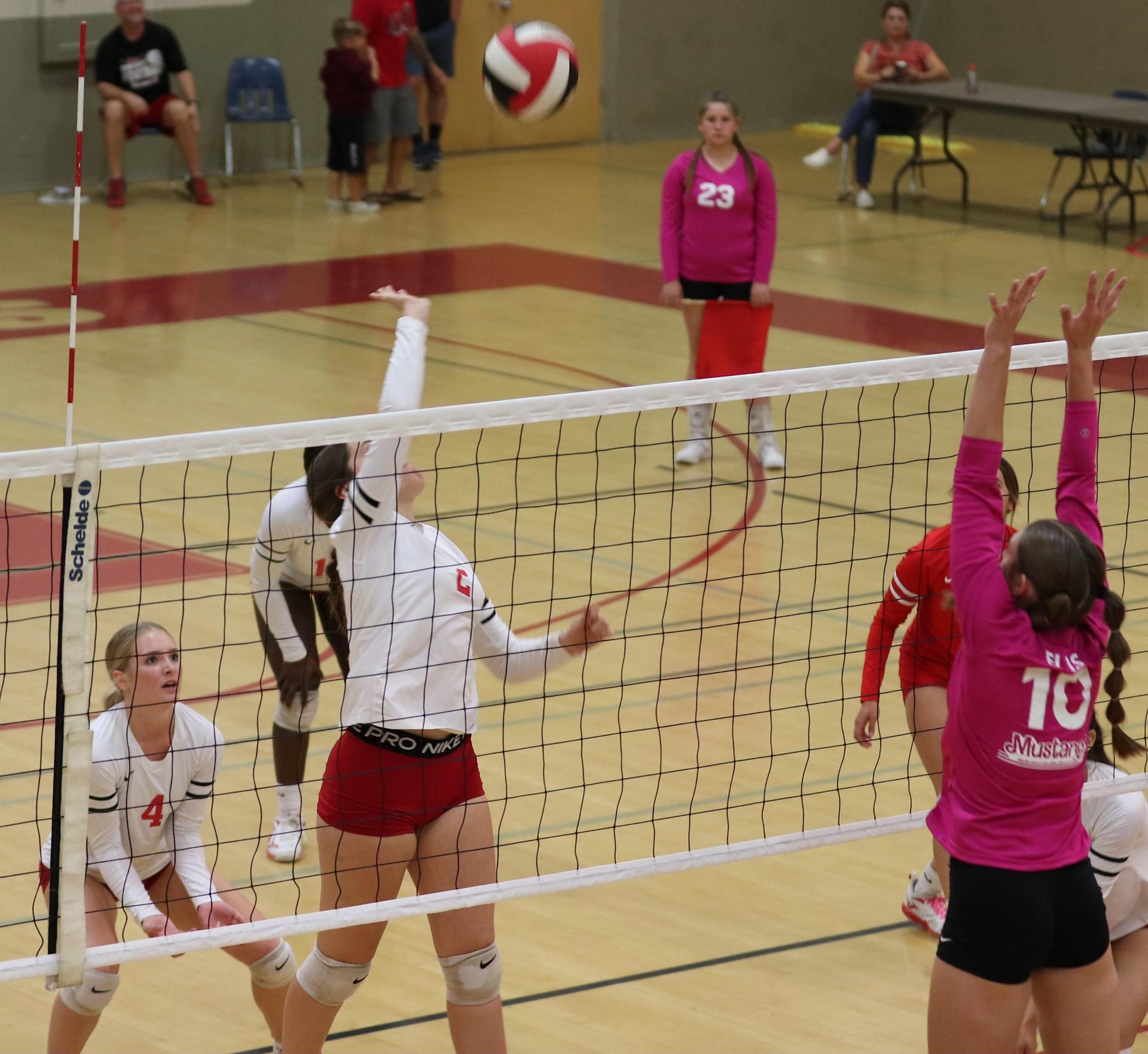 varsity volleyball players in action against Minarets