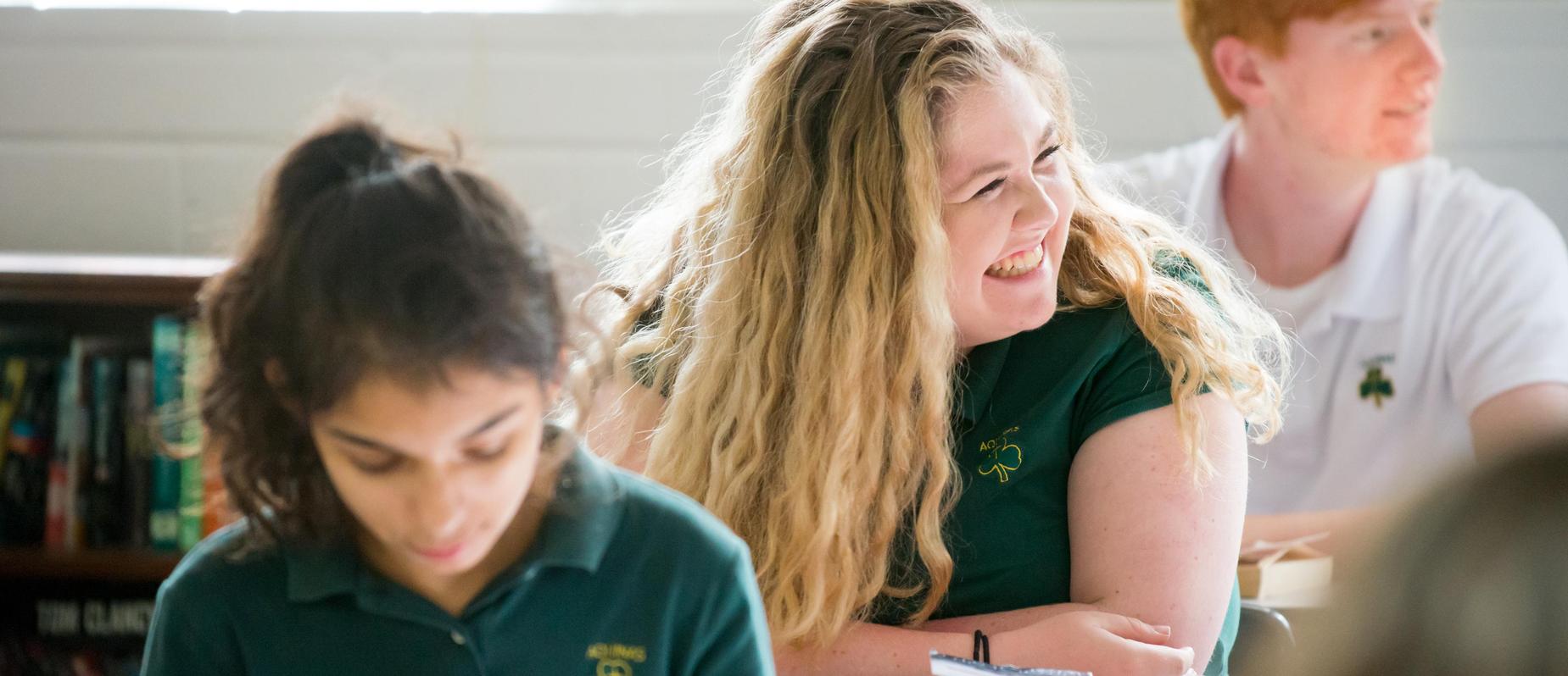 3 students listening in their english class