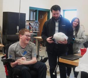 Kenan Smith hands Nate Boersma the signed Miami Dolphin football.