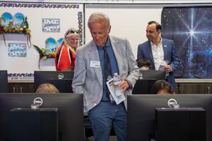 A CSBA visitor observes students working at computers inside the Starbase STEAM lab.