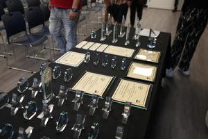 Display of awards and certificates on a table at an event.