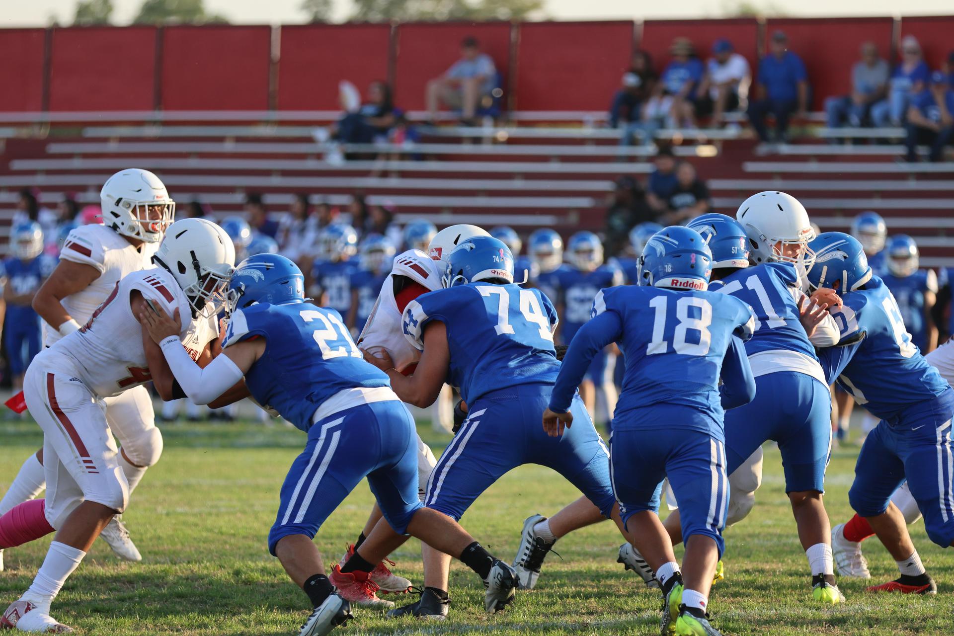 Junior Varsity football players in action against Caruthers
