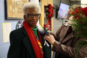 Holloway grad Florence Smith recieves a corsage from Principal Sumatra Drayton