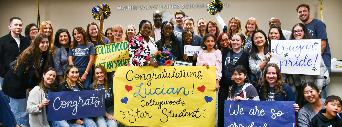 A crowd celebrating Lucian as Collegewood's Star Student, holding banners and colorful pom-poms.