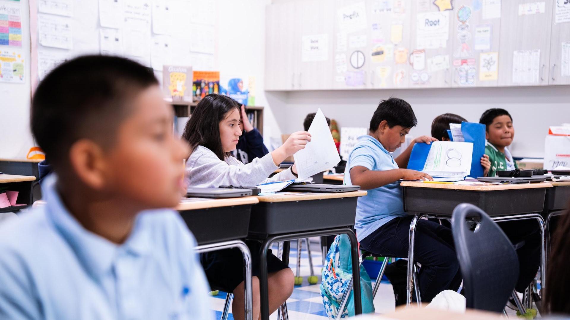 Students in a classroom actively participating in a lesson.