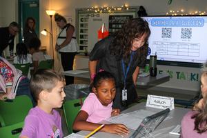 Students demonstrate their experiment to visitors during the PLTW Showcase