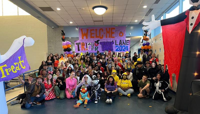 A group photo of volunteers with last year's Trick or Treat Lane