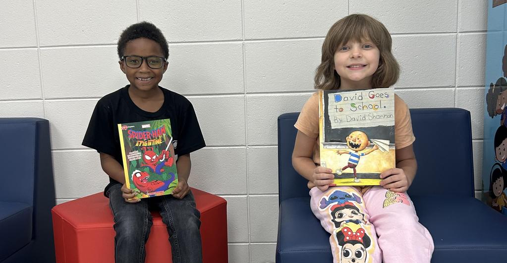 Students posing with their prize books for making a 100 on their AR test.