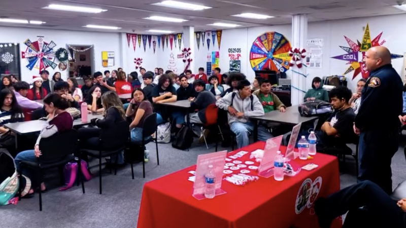 image of fireman taliking to students