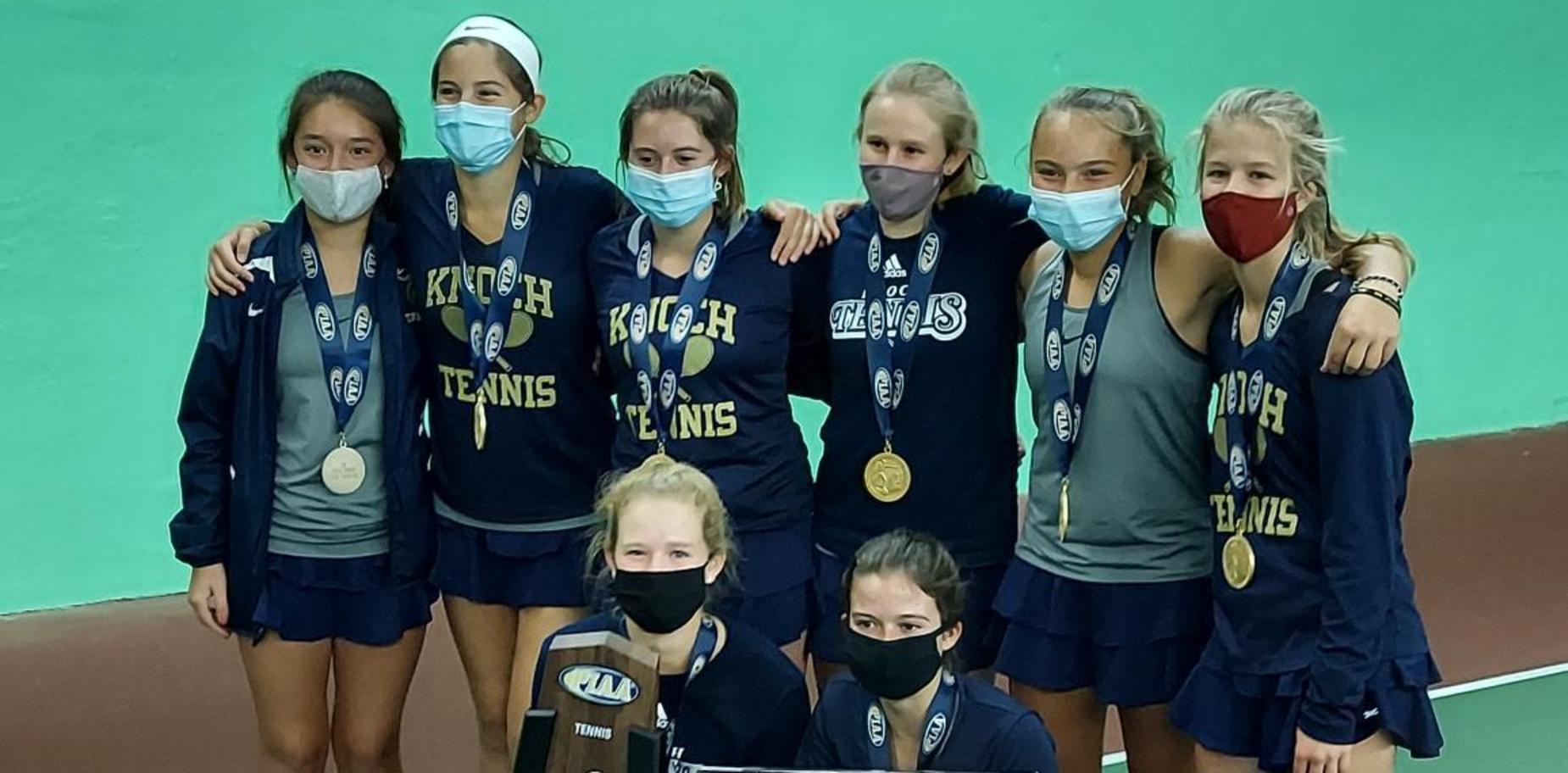 members of the tennis team with their trophy