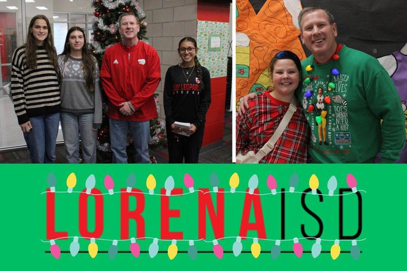 Christmas card contest winning students and Superintendent stading in front if a Christmas tree