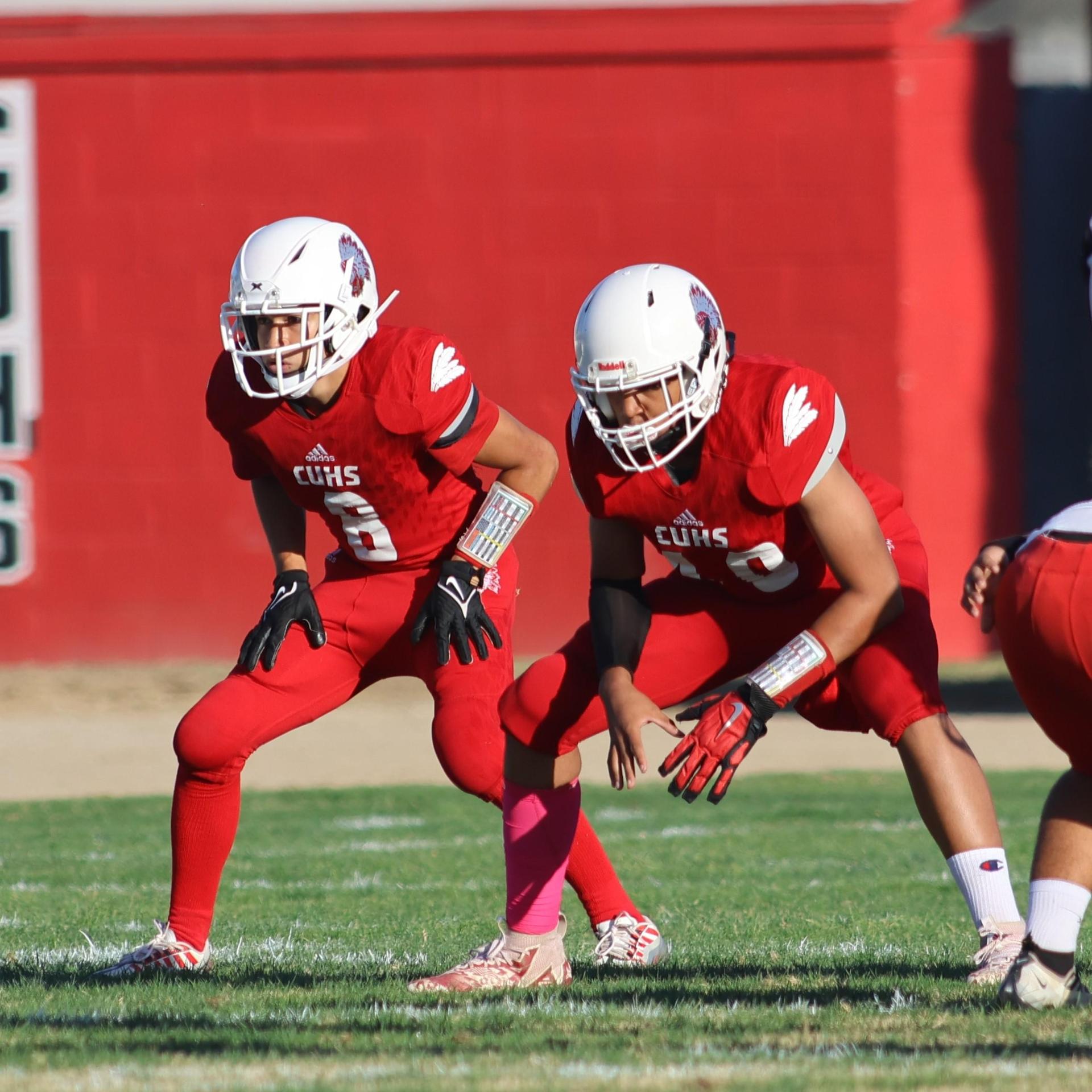 junior varsity football players in action against Fowler
