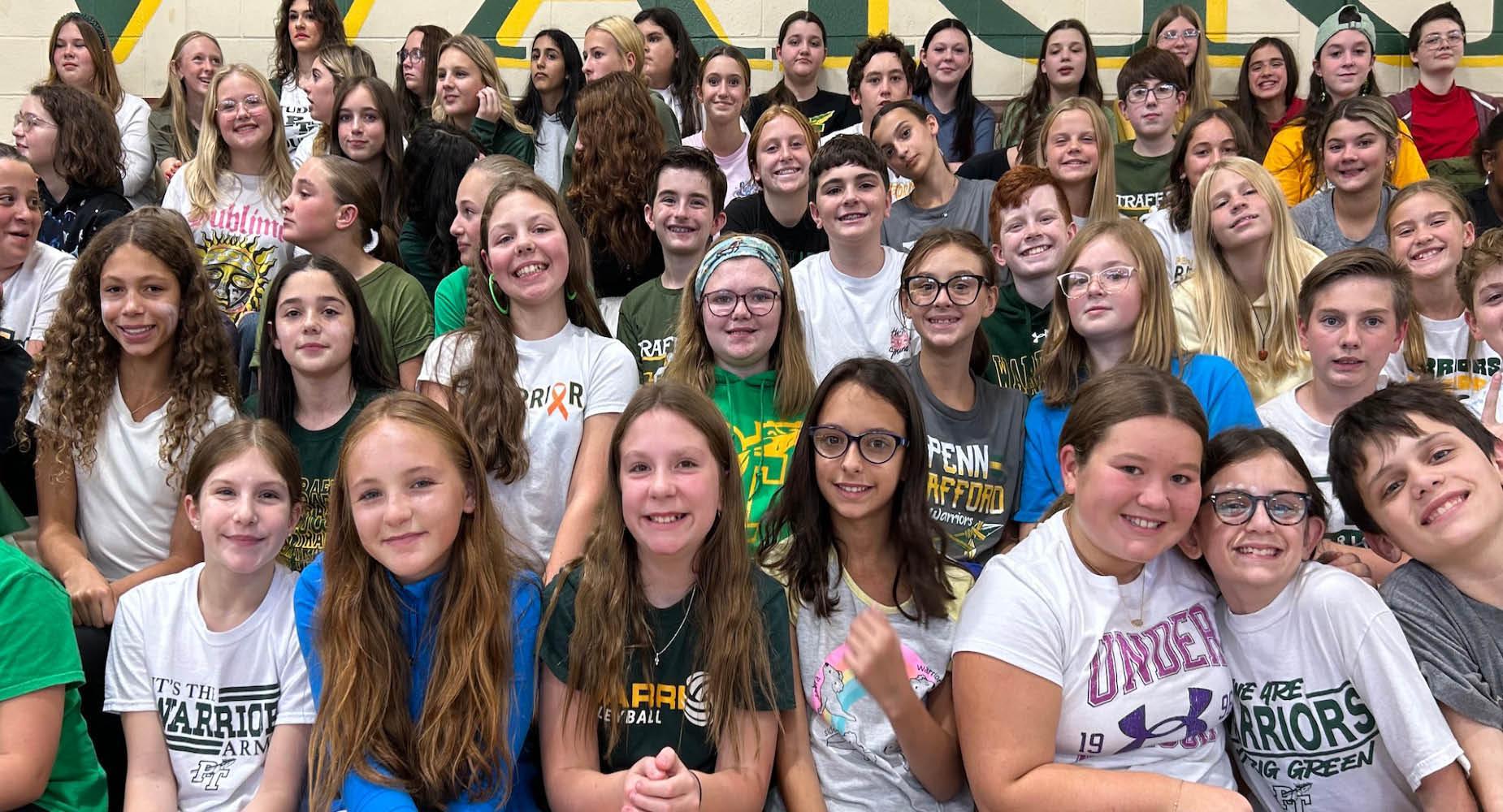 Trafford Middle School students sit in the bleachers during the Homecoming pep-rally
