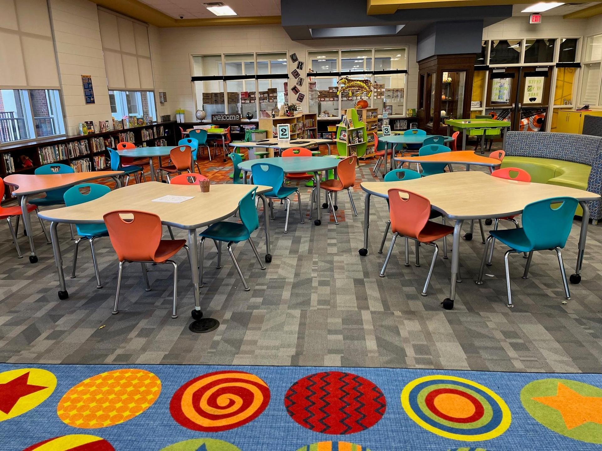 Grovetown Learning Commons space including tables, chairs, and shelves of books.