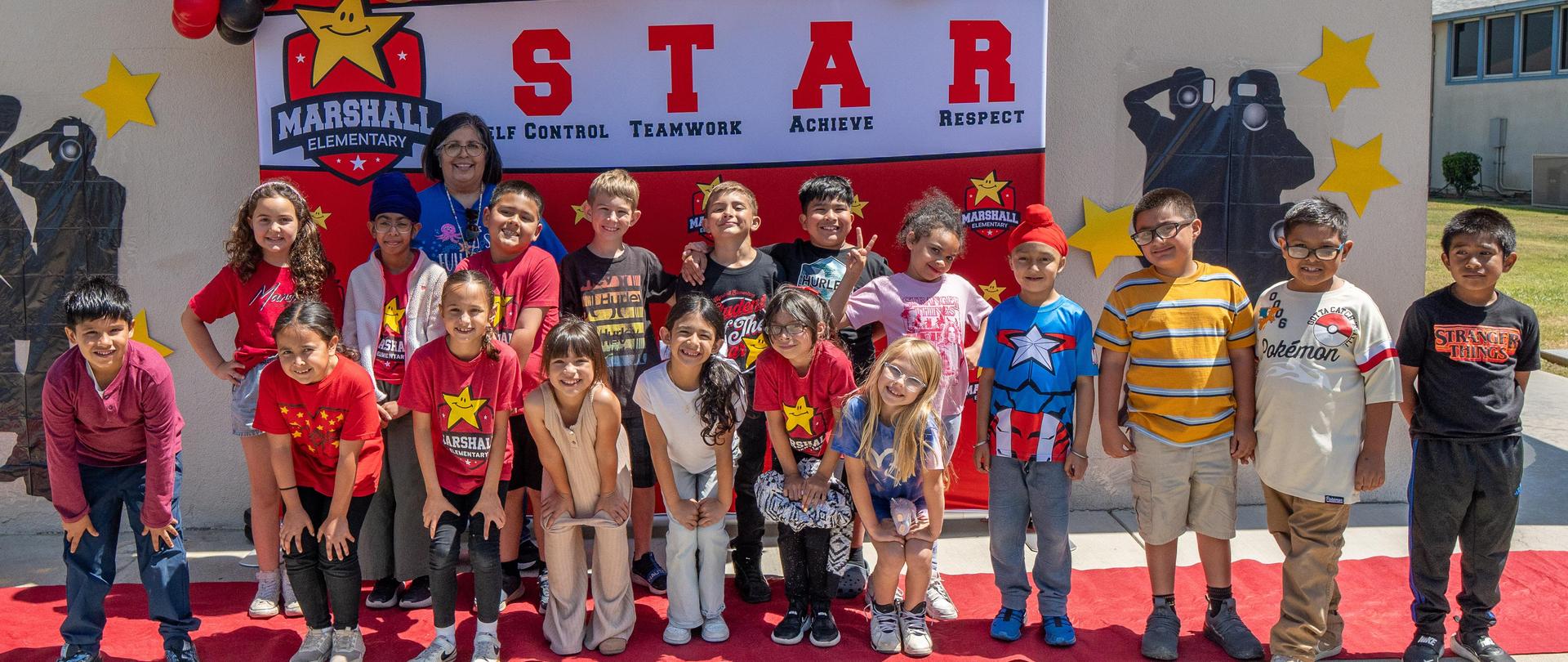Student of the year with teacher and classmates