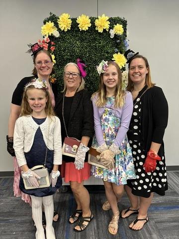 Mommy and me tea photo with moms and daughters wearing fun hats