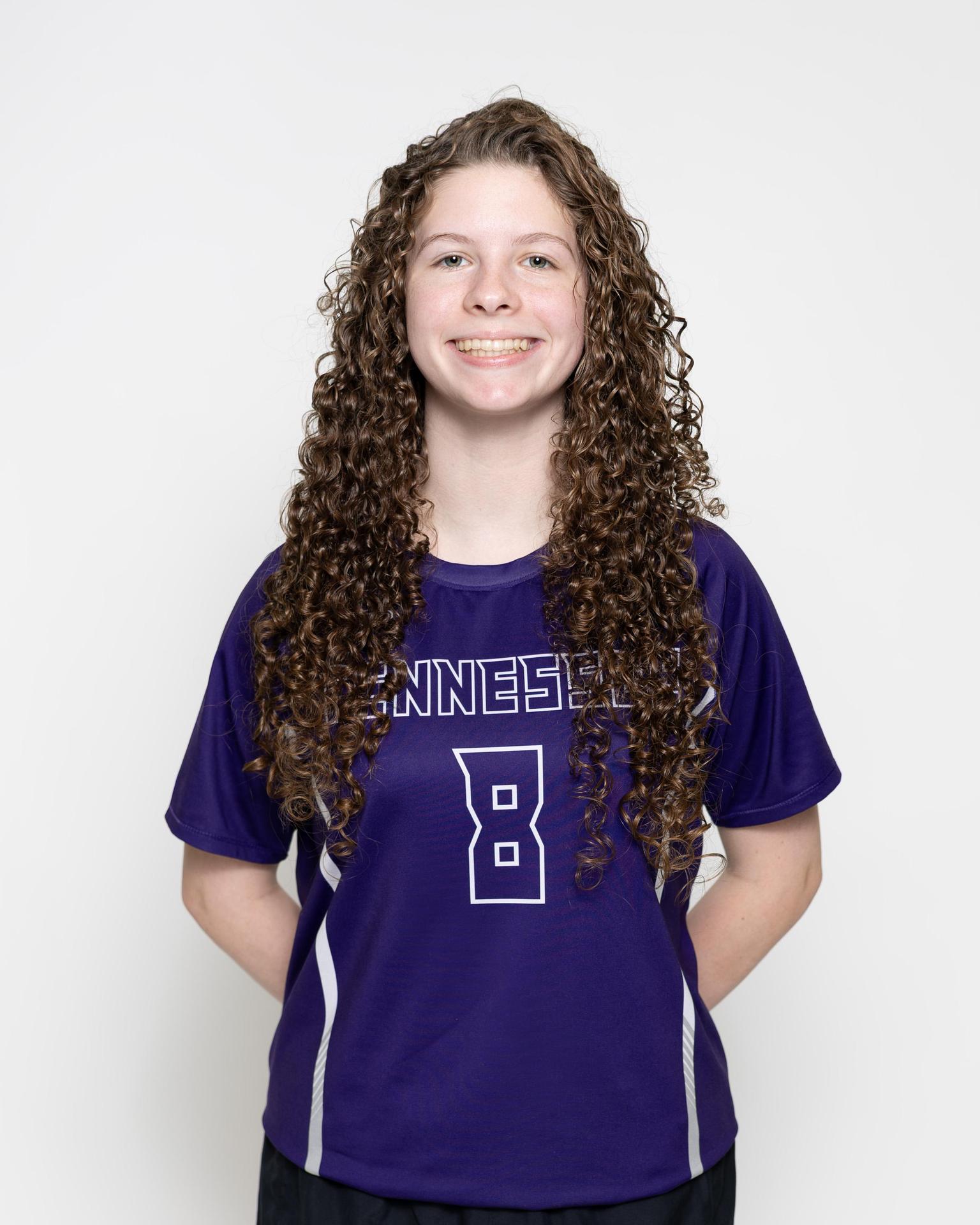 number 9 female volleyball player posing 