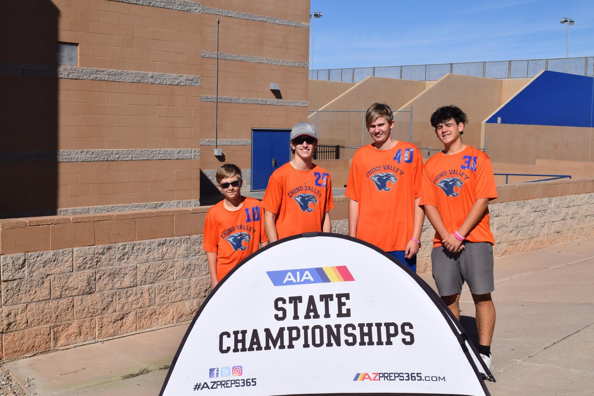 group of unified sports participants standing next to state championship sign