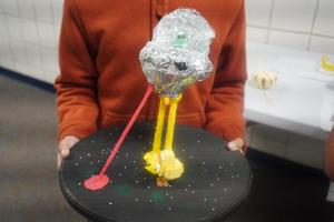 A student shows his alien spaceship gourd project.