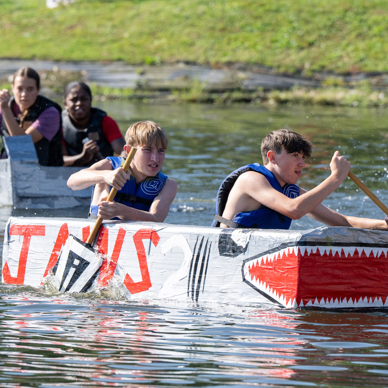 Students racing in cardboard boats