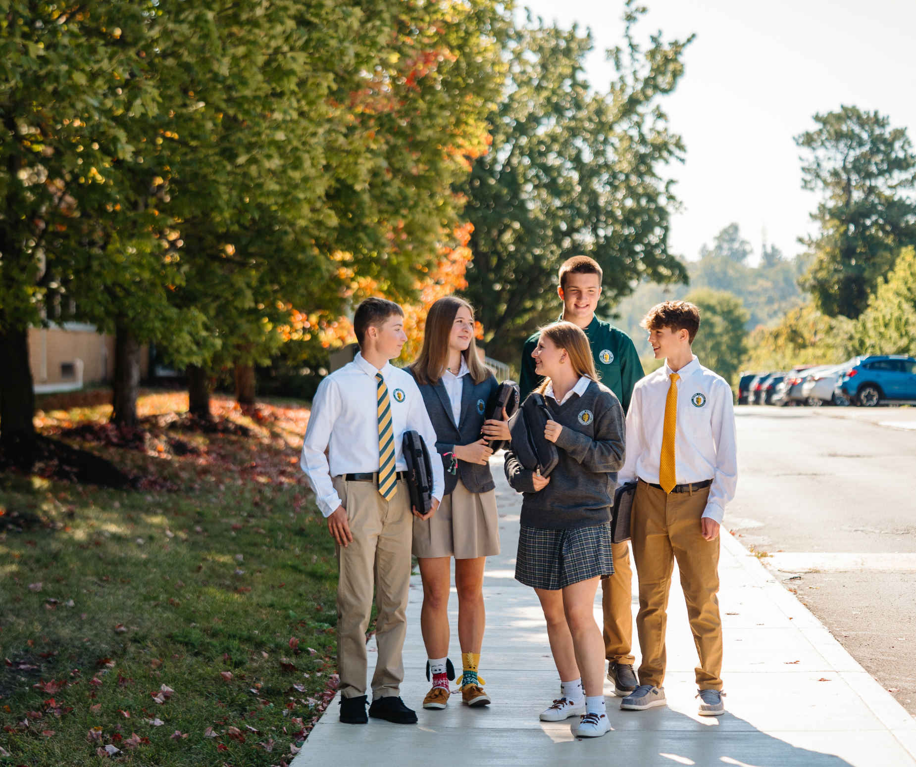 Group of students walking in front of the school