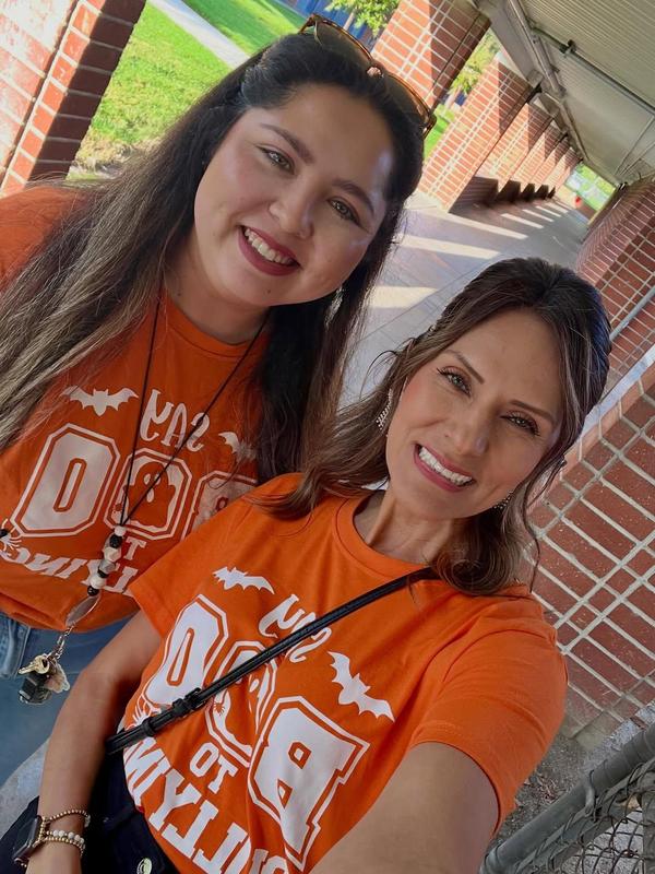 principal and staff in matching school spirit in hallway