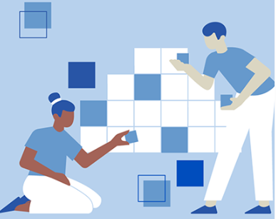 two students putting together blue and white puzzle pieces