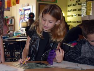 Students completing reading and math activities.