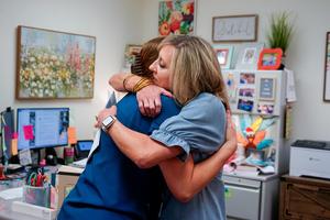 Kim Moore hugging Covenant Staff after donation presentation