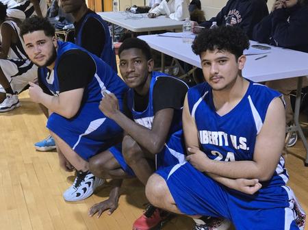 IHS Basketball Team Kneeling on Gym Floor