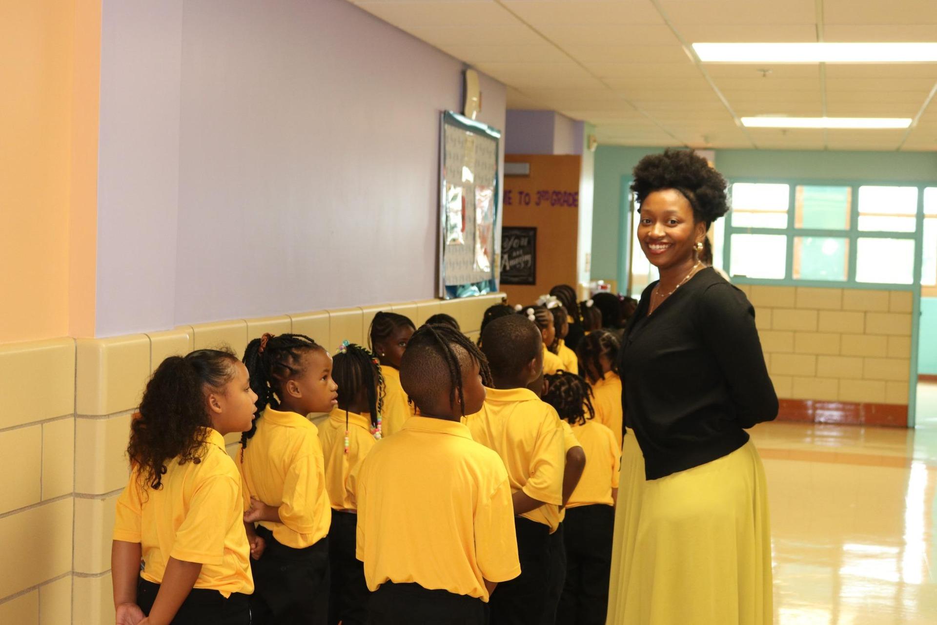 PECS Staff smiling with lined up students