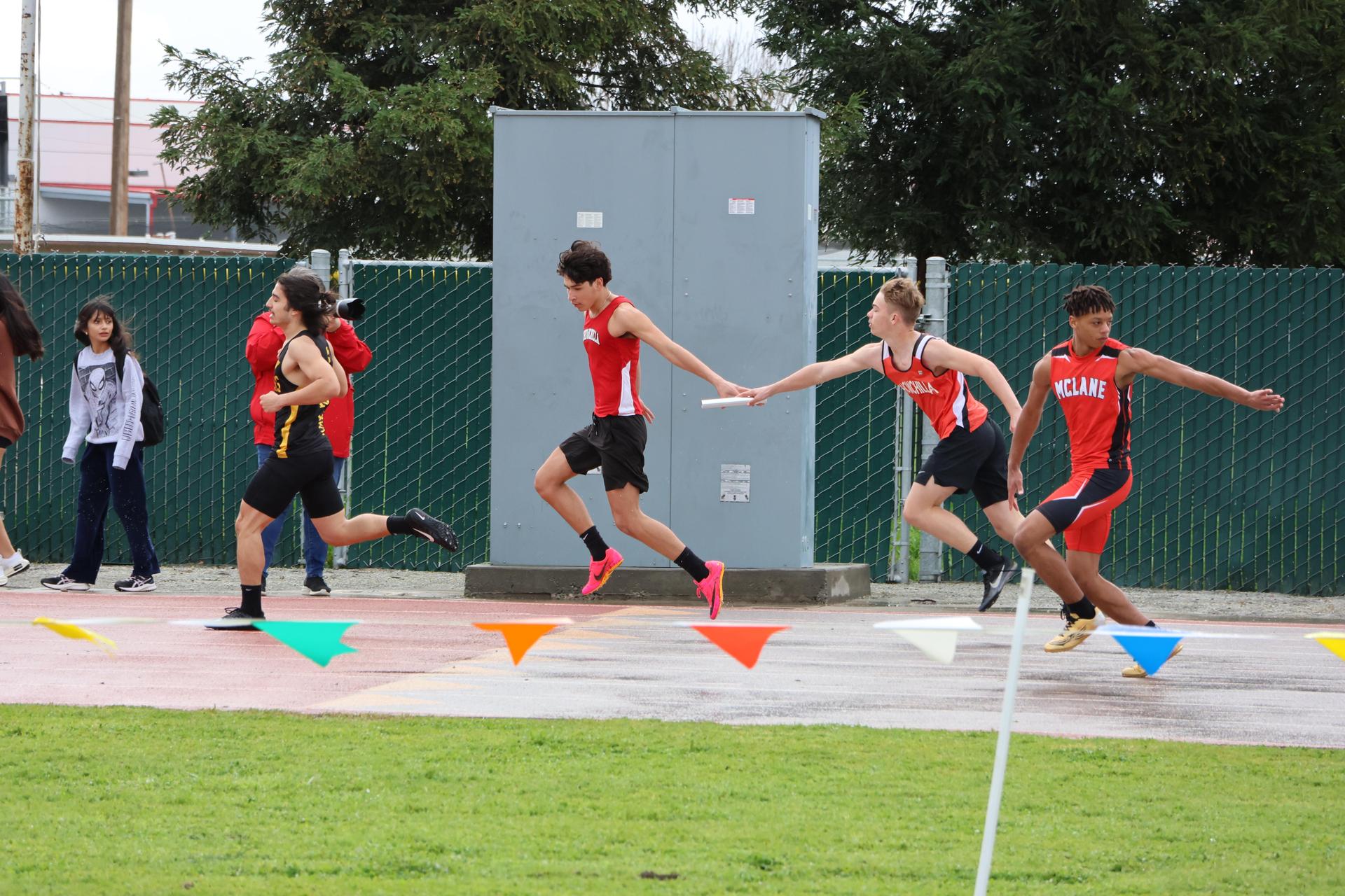 junior varsity boys running the four by 100 meter relay