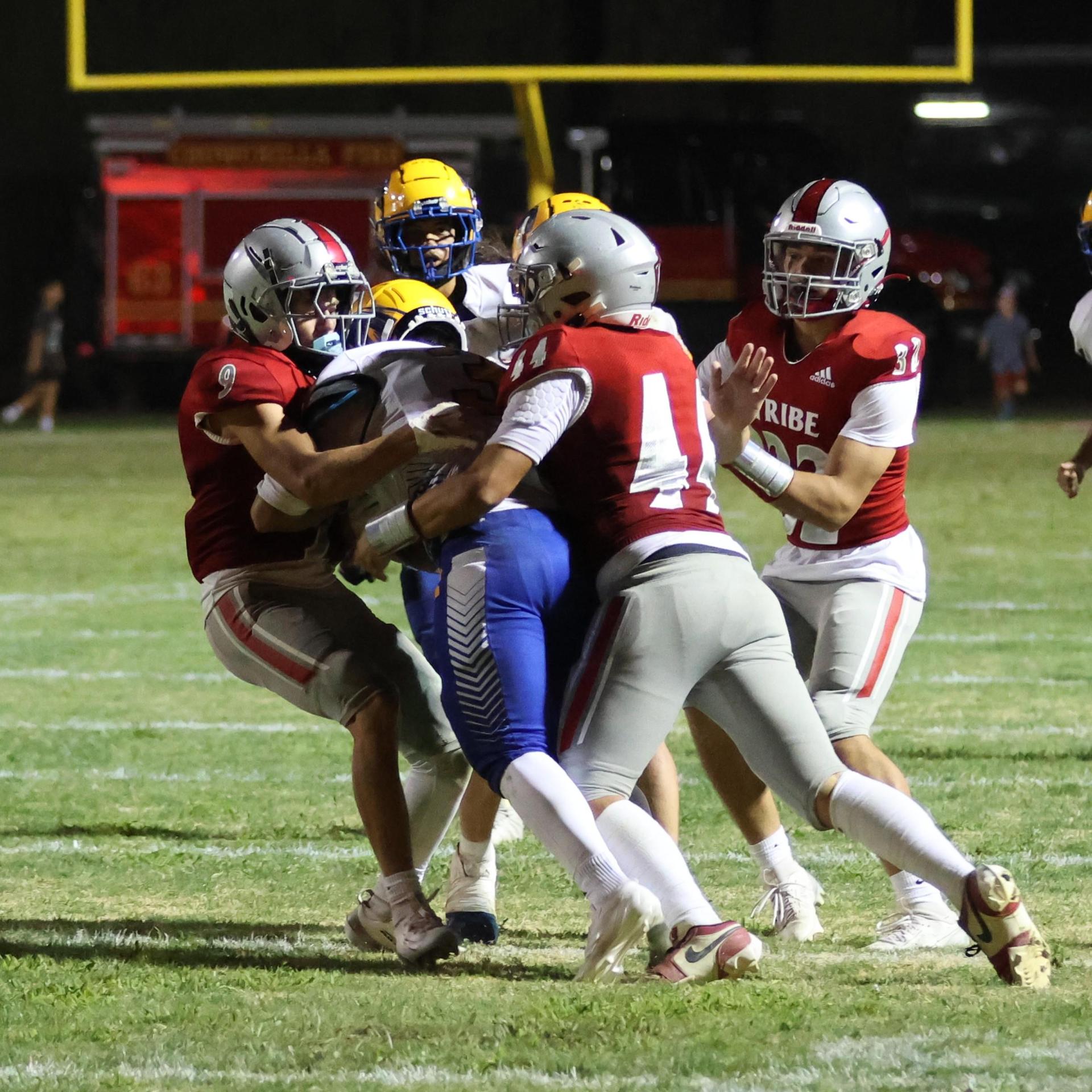 Varsity football players in action against Parlier 73