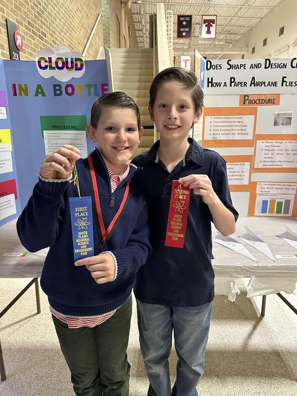 Two Ridgewood boys at with their ribbons from the regional science fair