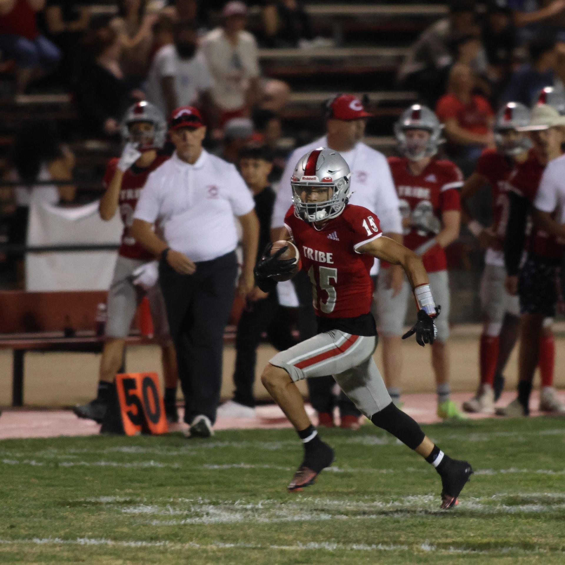 Varsity football players in action against Parlier 145