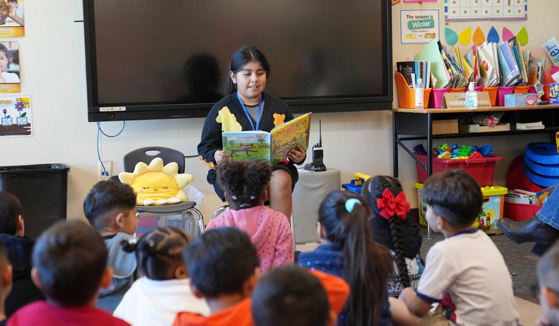 Girl reading to a class