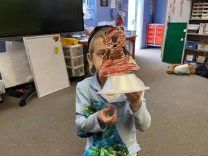 A kindergarten boy with a groundhog model.