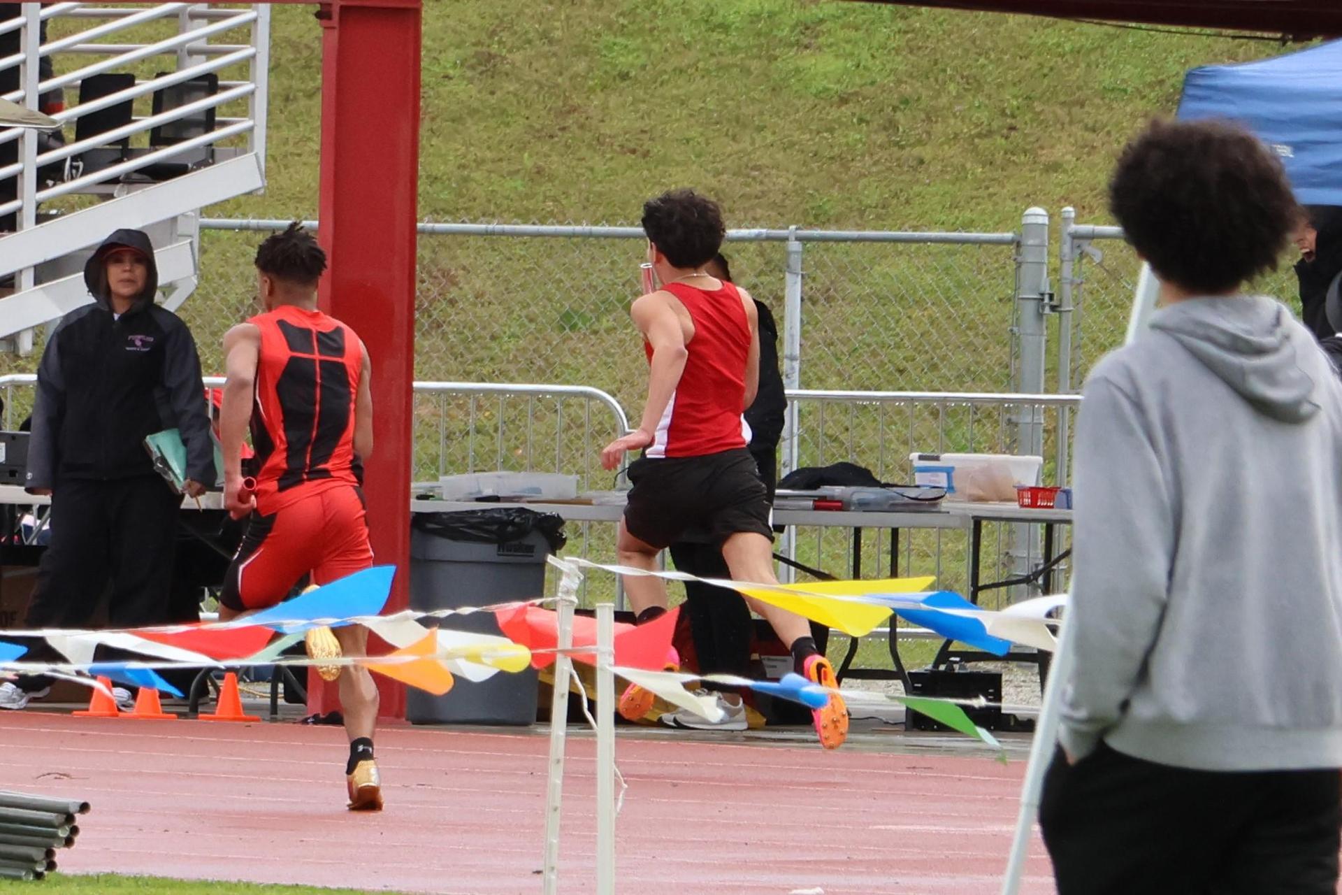 junior varsity boys running the four by 100 meter relay