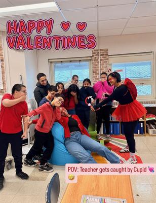 Group of students in red attire celebrating Valentine's Day with a playful theme.