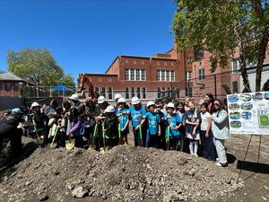 group of people with shovels at groundbreaking ceremony