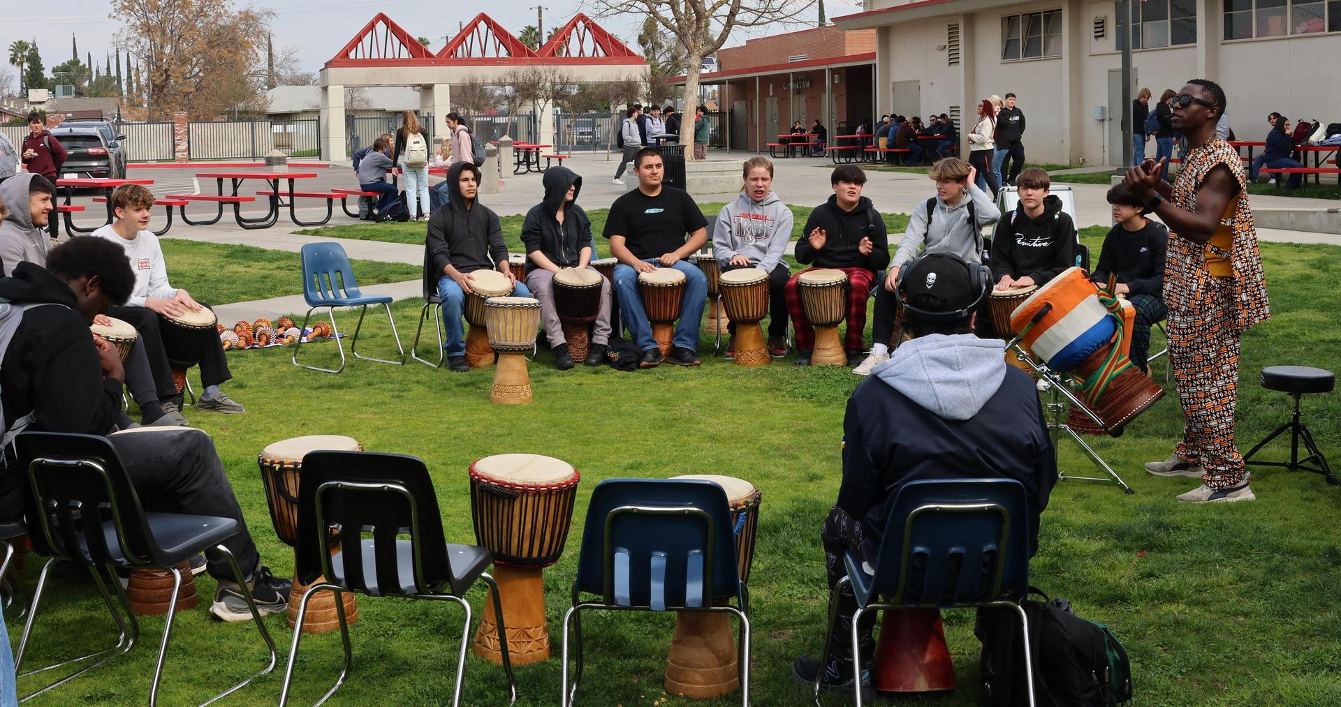 students and staff participating with the African Drum Interactive