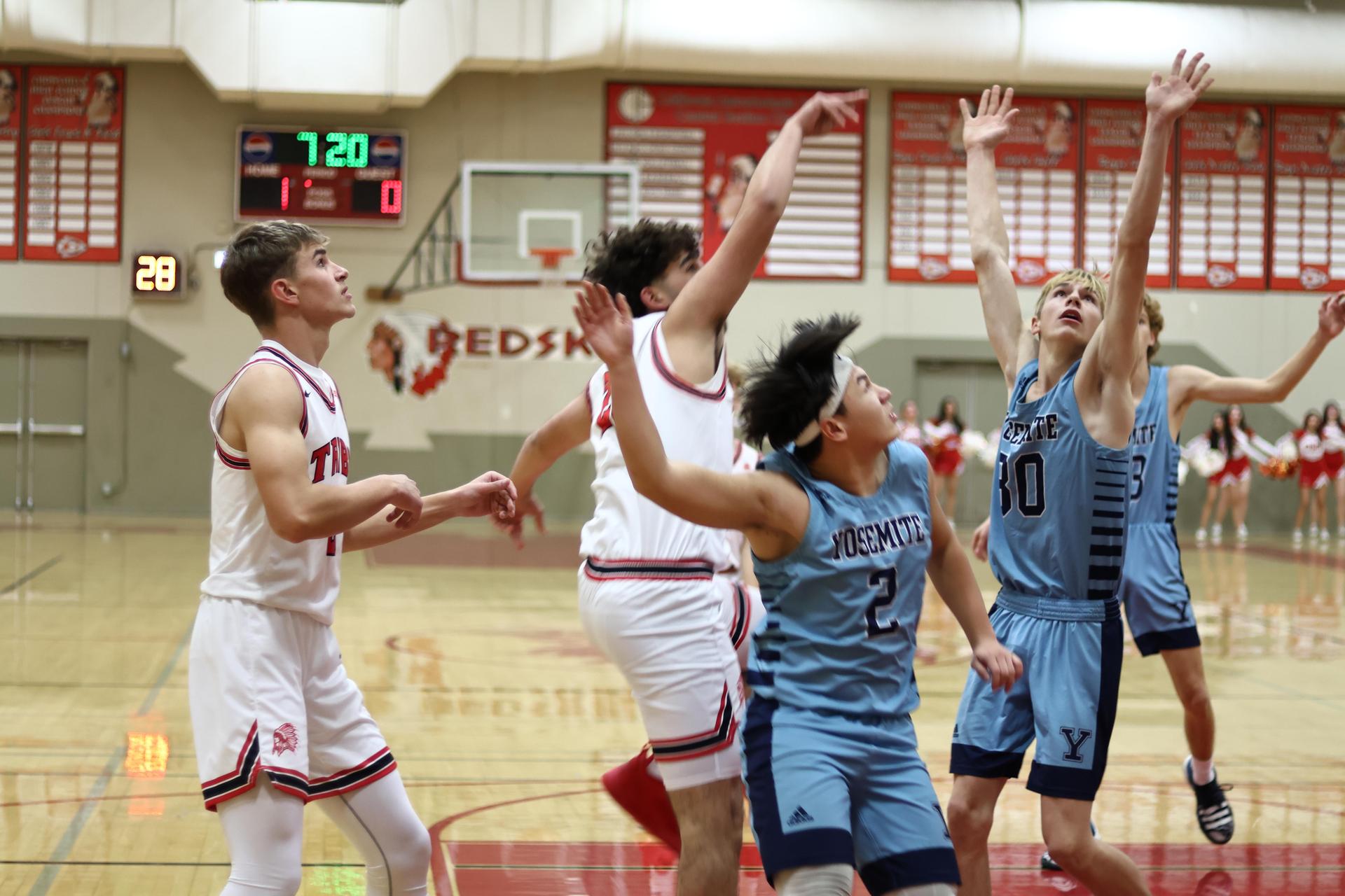 Varsity boys playing basketball against yosemite