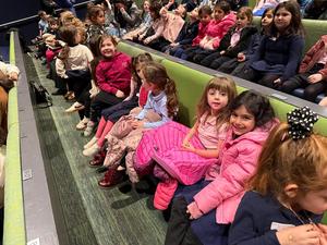 The Kindergarten girls watch a puppetry performance.