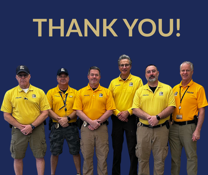 six officers in bright yellow polos looking at camera with thank you written above them
